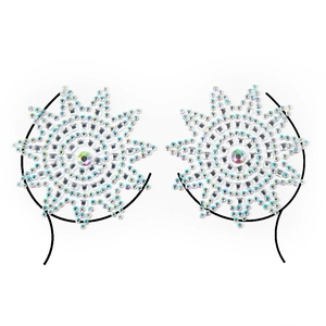 Macro shot of sun-shaped acrylic rhinestone chest jewelry for EDM festivals and parties
