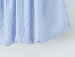 Macro shot of blue and white thin striped fabric texture for backless halter dress