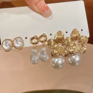 Three-pair set of French vintage pearl earrings with gold floral and heart pendant designs