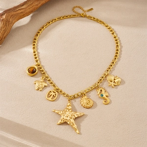 Gold stainless steel starfish necklace with beach charms including seashell and seahorse