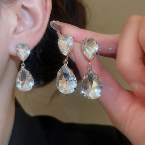 Elegant gold-tone teardrop tassel earrings and necklace set with sparkling crystals