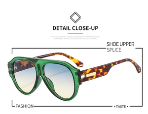 Detail of oversized sunglasses with green translucent frames and tortoiseshell temples
