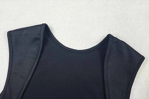 Close-up of the neckline and stitching detail on a black sheer mesh athletic bodysuit