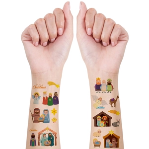 Close-up of Christmas Nativity scene temporary tattoos applied on the inner forearm