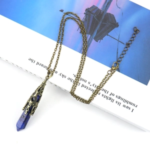 Detailed macro of the dark blue hexagonal crystal pendant and retro bronze filigree cap