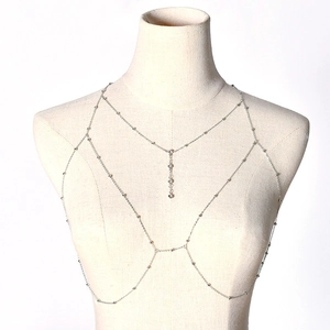 Silver body chain with tassel rhinestones on a beige mannequin, professional studio view