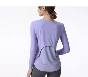 Detail of purple long sleeve yoga top featuring breathable mesh拼接 at the hem