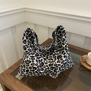 Large capacity leopard print canvas tote bag on a wooden table with a coffee cup