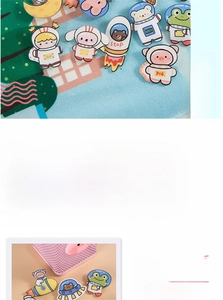 Detail of cute acrylic animal astronaut brooches featuring bear and pig designs