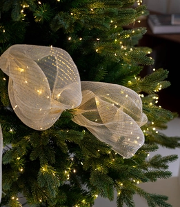 Golden mesh Christmas ribbon with built-in LED lights wrapped around tree needles