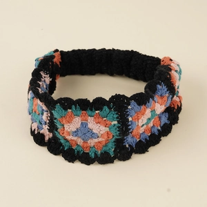 Detailed close-up of a colorful crochet granny square headband with floral knit patterns