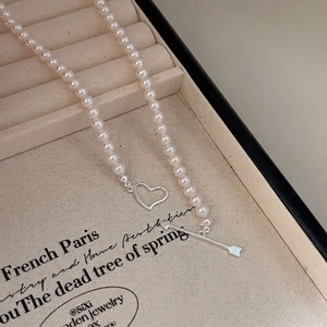 925 silver Cupid heart and pearl necklace displayed elegantly in a beige jewelry box
