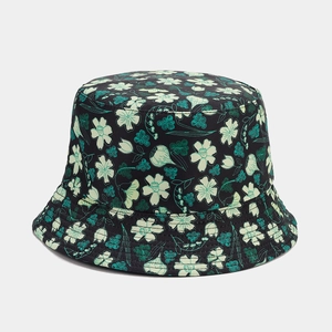 Close-up of black cotton bucket hat featuring green floral print and neat stitching