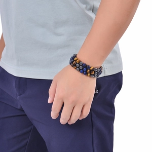 Detail of 8mm triple tiger eye stone beads on a woven adjustable bracelet for men