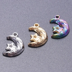Detailed view of crescent moon and star charms in gold, silver, and rainbow steel