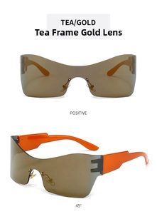 Macro detail of Y2K rimless sunglasses with gold film lenses and bright orange temples