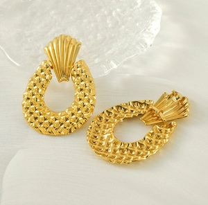 Detail of 18K gold plated seashell earrings with textured U-shaped geometric pendants