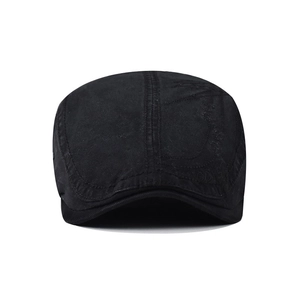 Close-up of black cotton flat cap featuring vintage stitching and subtle embroidery detail