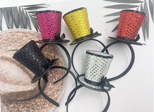 Detail of five assorted sequin mini top hat headbands in pink gold red black and silver