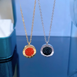 Close-up of titanium steel necklaces with Roman numeral pendants and faceted crystals