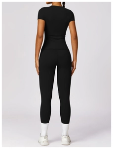 Rear view of sleek black high-waist yoga leggings and matching athletic compression tee