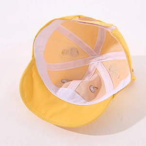 Detail view of cotton baby hat interior with sweatband and breathable vent holes