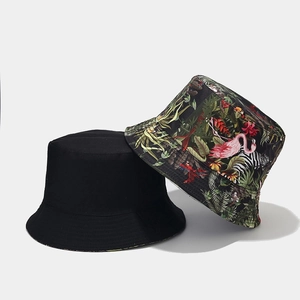 Detail of reversible bucket hat showing black side and tropical flamingo zebra print