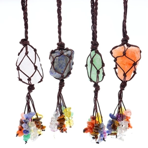 Macro detail of four handcrafted crystal stone pendants with woven nets and colorful tassels