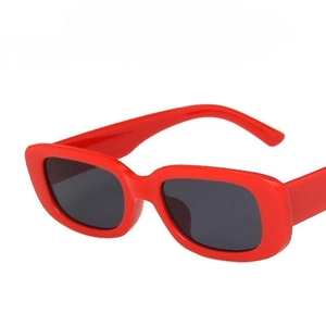 Retro red rectangular frame sunglasses with dark lenses in a minimalist vintage style