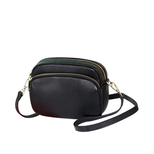 Klassieke zwarte leren crossbodytas met dubbele ritsen en goudkleurige hardware details