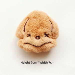 Detail view of 7x7cm fluffy brown plush dog pin with cute embroidered facial expressions