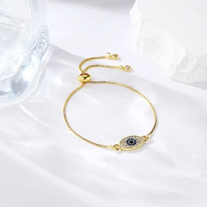Detail of adjustable gold evil eye bracelet with blue zircons and sliding clasp