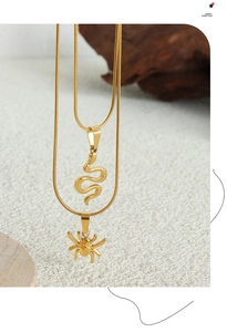 Detail of gold snake and spider pendants on snake bone chain necklaces for women