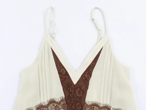 Detail of beige and brown camisole with lace trim and pleated texture on the V-neckline