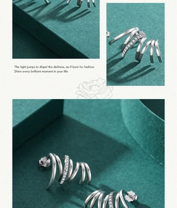 Macro detail of S925 sterling silver multi-layer spiral earrings with zircon inlay