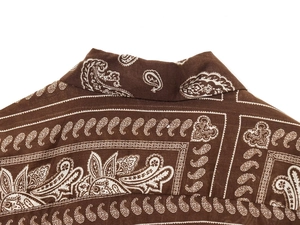 Detail of paisley print on brown cotton linen shirt collar and shoulder section
