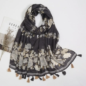Detailed view of floral cotton linen scarf with elegant tassels and paisley pattern