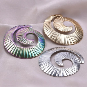 Detailed view of spiral textured pendants in gold, silver, and gradient multicolor finish