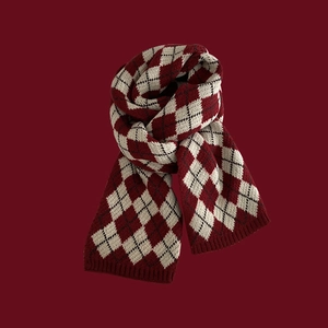 Close-up of red and white diamond knit scarf with soft texture on red background