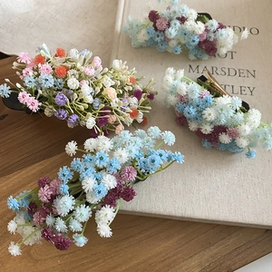Close-up of elegant acrylic flower cluster hair clips in various pastel color palettes