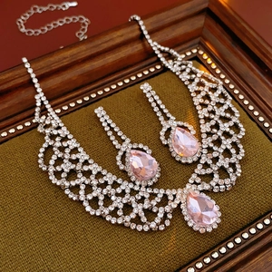 Macro view of teardrop pink crystal necklace and earring set in vintage frame