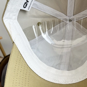 Detail view of khaki baseball cap interior showing 100% cotton lining and sweatband