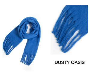 Detailed close-up of soft blue mohair scarf with elegant fringe and woven texture