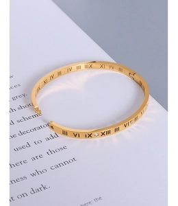 Detail of gold roman numeral bangle with sparkling cubic zirconia insets