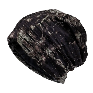 Distressed camouflage knit beanie with ripped details and black marble pattern for men