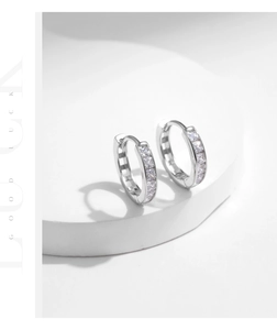 Macro detail of U-shaped s925 silver hoop earrings with sparkling cubic zirconia inlay
