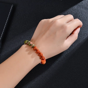 Natural sunstone and pink crystal beaded fertility bracelet on a female model's wrist