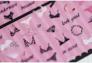 Close-up of 5D ultra-thin nail stickers featuring lingerie motifs and secret typography