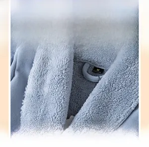 Close-up of shawl collar on thick blue fleece bathrobe showing soft texture and M size label