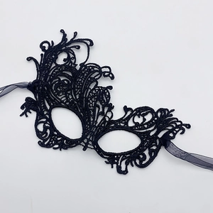 Detailed view of intricate black lace embroidery on gothic masquerade party mask